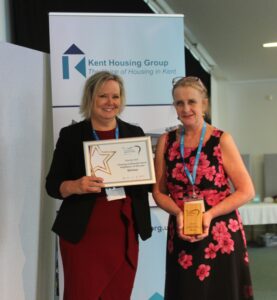 Mandy Relf collecting her unsung community hero award from Vanessa Biddiss, Southern Housing
